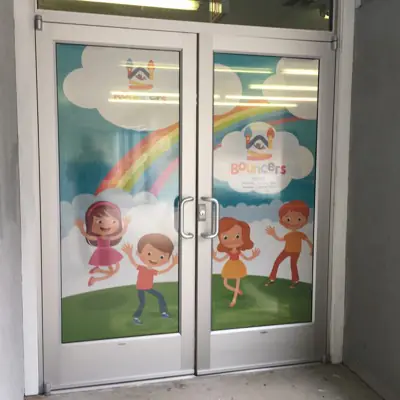 Perforated one-way window graphic applied to storefront glass (example 4)